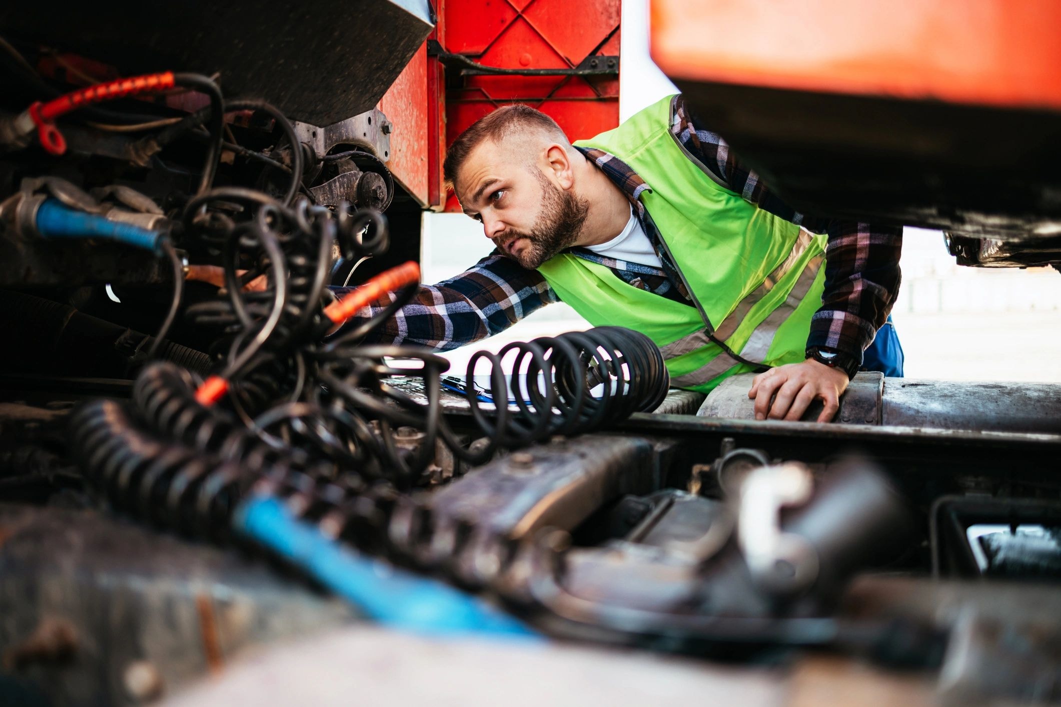 Mechanic working under a vehicle engine